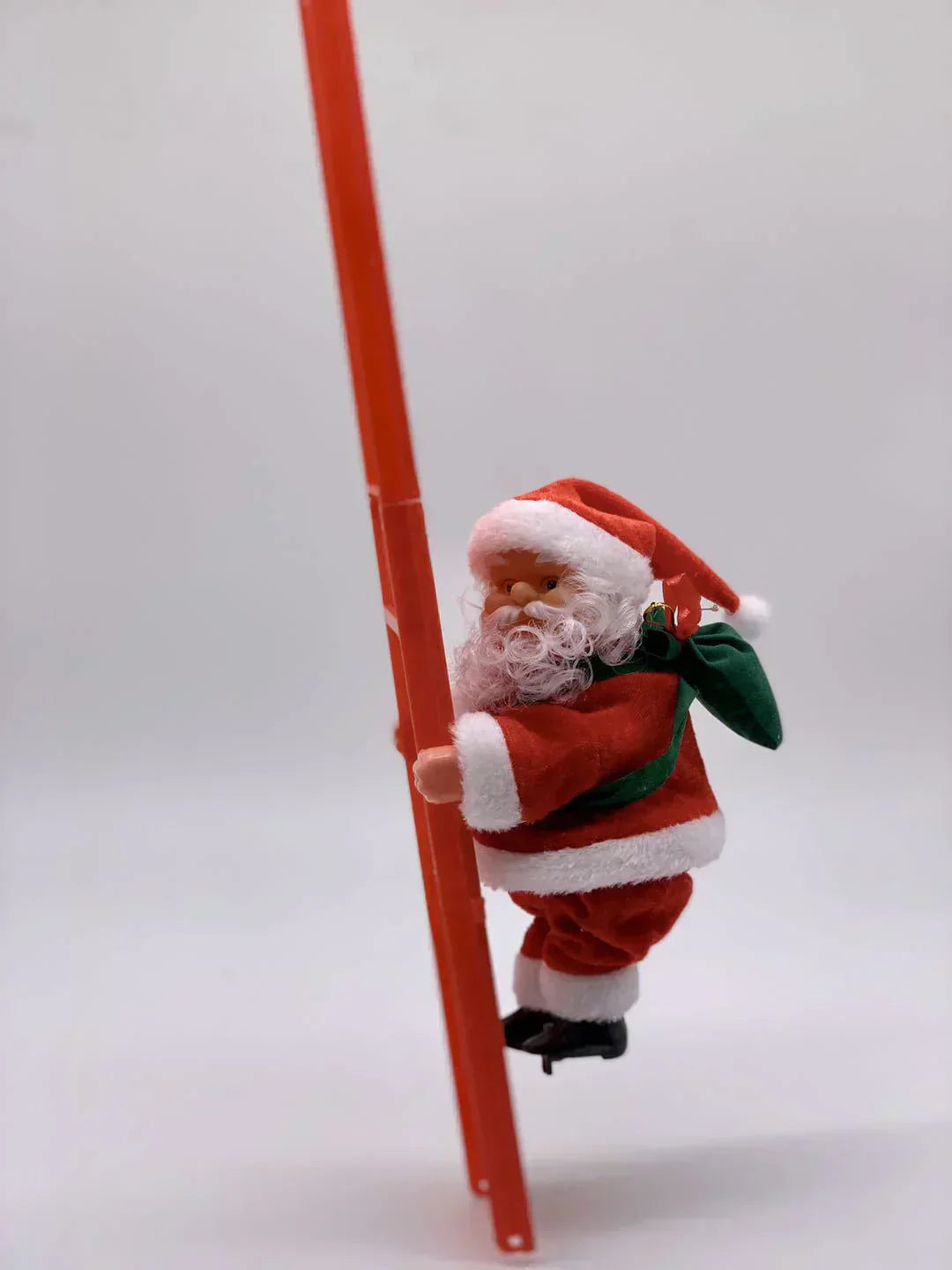 🎄Elektryczna zabawka muzyczna przedstawiająca Świętego Mikołaja wspinającego się po kominie